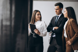 Male And Female Business People Working On Tablet In Office - PAVON | Contabilidade em São Paulo