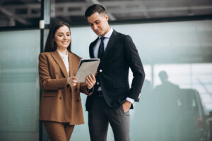 Male And Female Business People Working On Tablet In Office - PAVON | Contabilidade em São Paulo