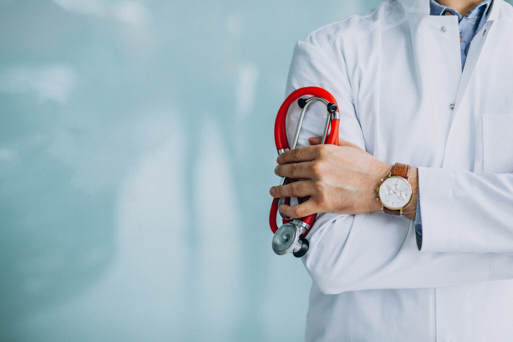 Young Handsome Physician In A Medical Robe With Stethoscope - PAVON | Contabilidade em São Paulo