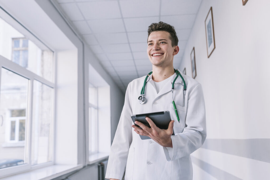 Cheerful Young Doctor With Tablet Hall - PAVON | Contabilidade em São Paulo