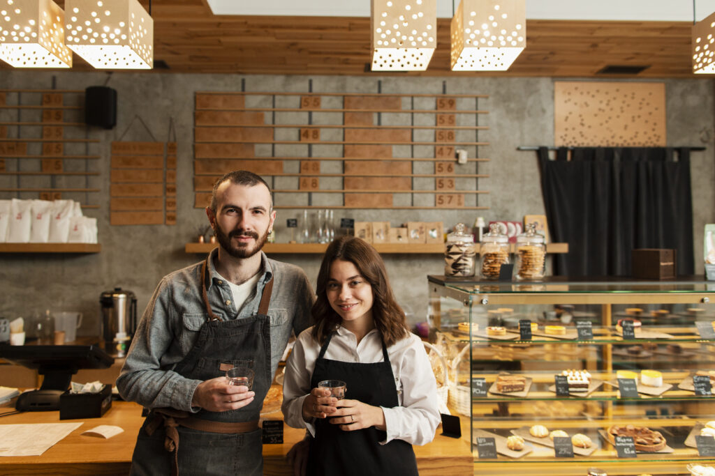 Couple Aprons Posing With Cups Coffee - PAVON | Contabilidade em São Paulo