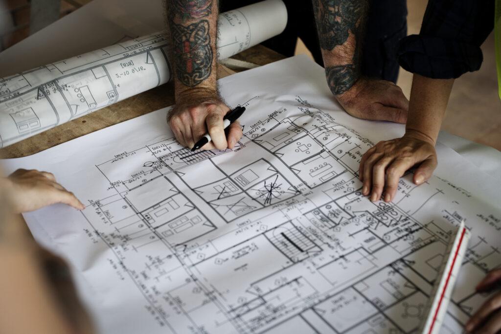 Architect Working On A Blueprint For A New Project - PAVON | Contabilidade em São Paulo