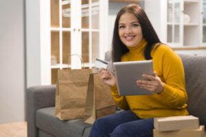 Smiley Woman Checking Tablet New Purchase - PAVON | Contabilidade em São Paulo