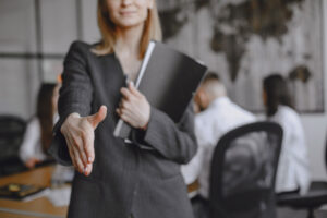 Woman In A Suit Holds A Folder. - PAVON | Contabilidade em São Paulo