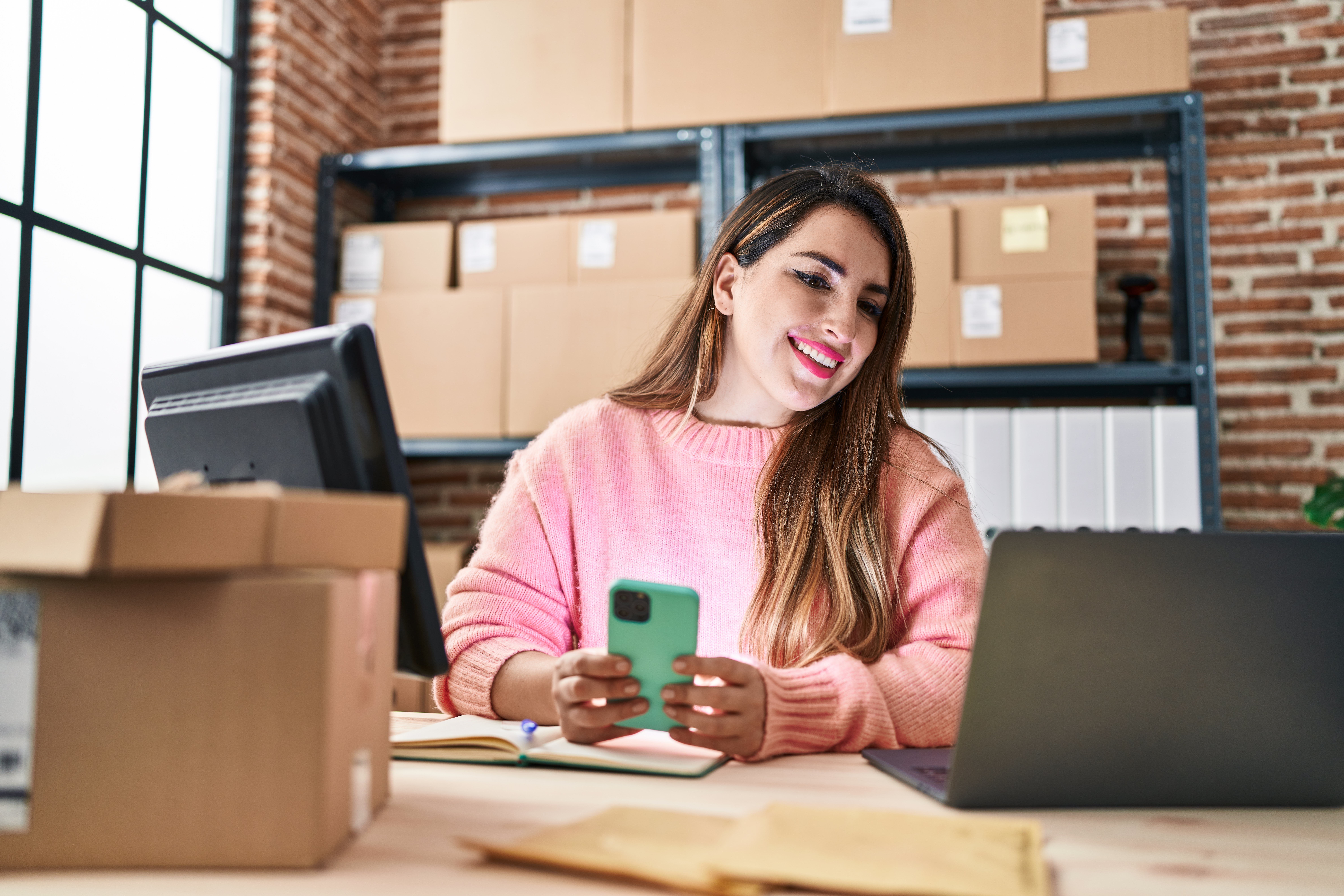 Young Beautiful Hispanic Woman Ecommerce Business Worker Using Smartphone At Office - PAVON | Contabilidade em São Paulo