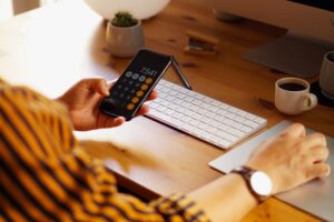 Closeup Shot Of An Entrepreneur Working From Home And Doing Calculations - PAVON | Contabilidade em São Paulo