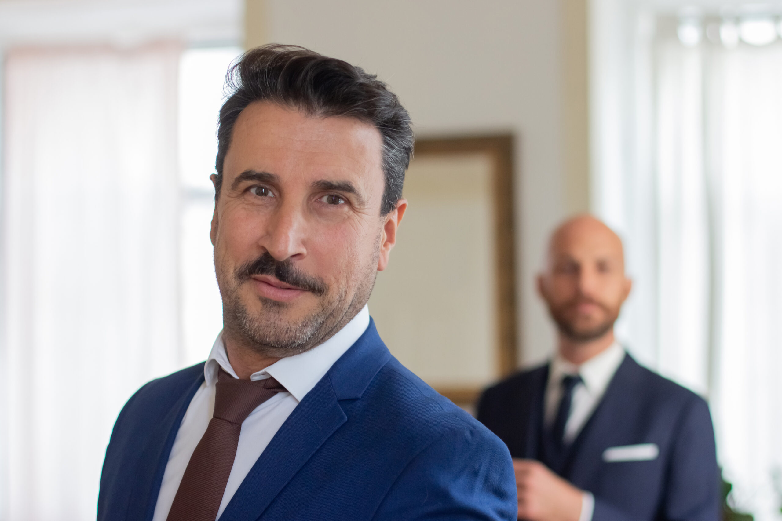 Handsome Gay In Official Suit Looking At Camera - PAVON | Contabilidade em São Paulo