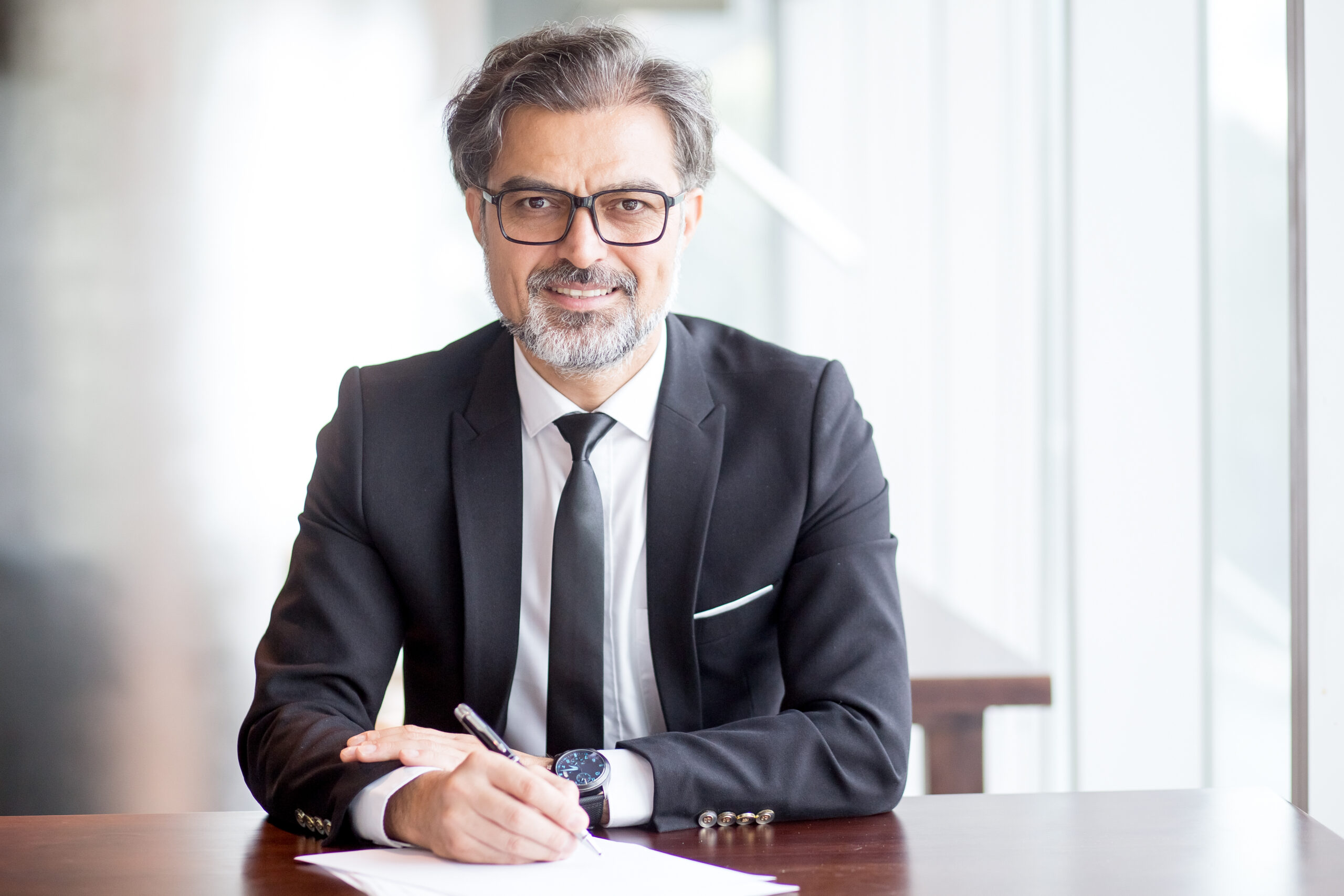Smiling Handsome Business Leader Making Notes - PAVON | Contabilidade em São Paulo