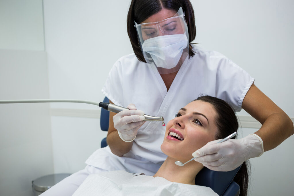 Dentist Examining A Female Patient With Tools At Dental Clinic - PAVON | Contabilidade em São Paulo