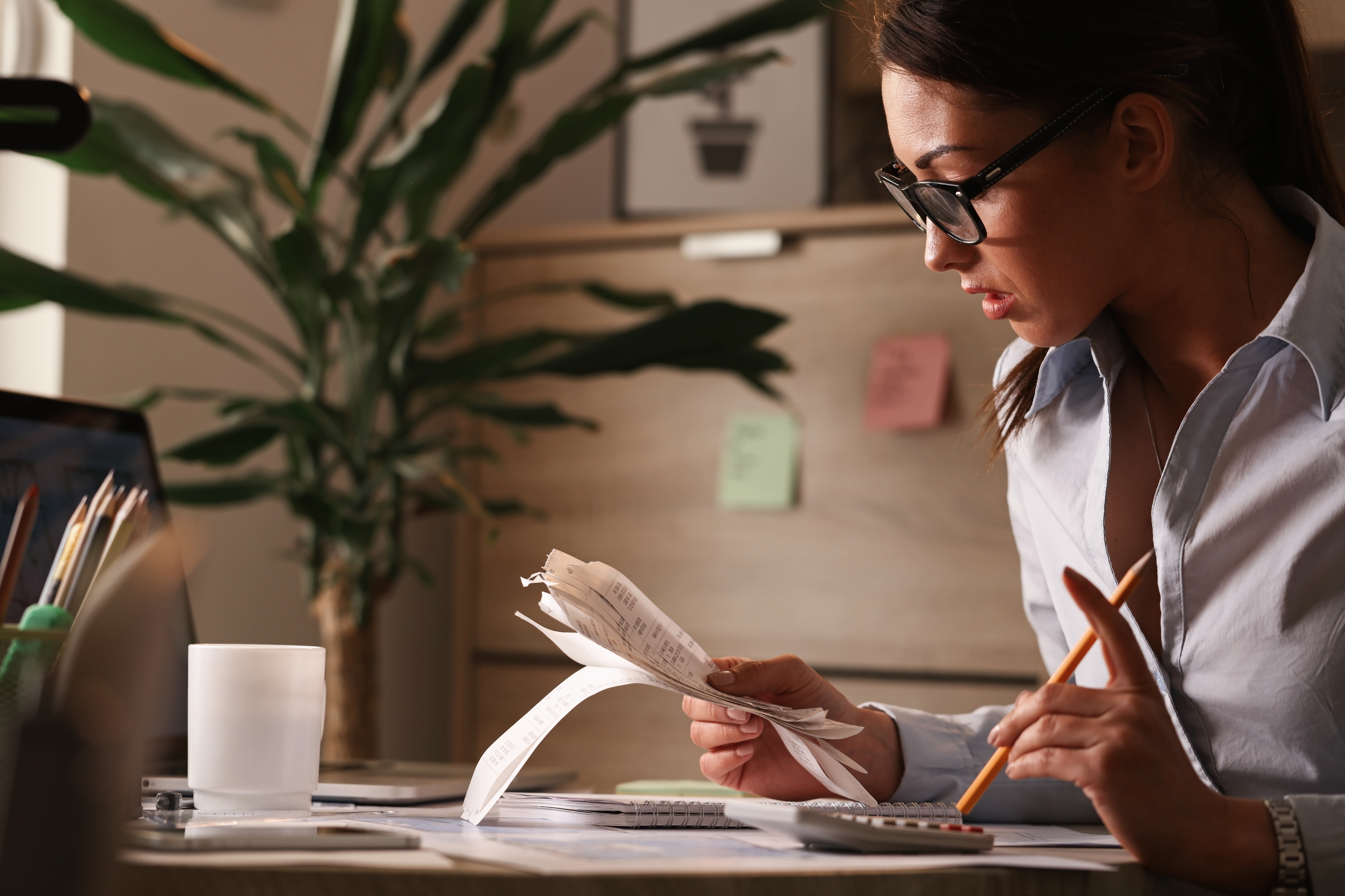 Young Businesswoman Going Through Finances And Analyzing Bills In The Office. - PAVON | Contabilidade em São Paulo